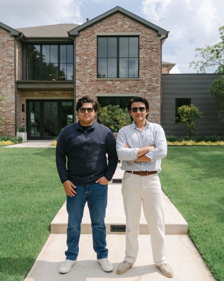 Adrian Posoz and Aidan Wong in front of a finished home